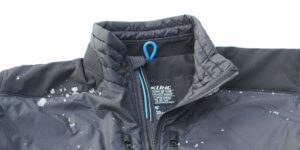 This image shows the KÜHL FIREFLY jacket front with some snow.