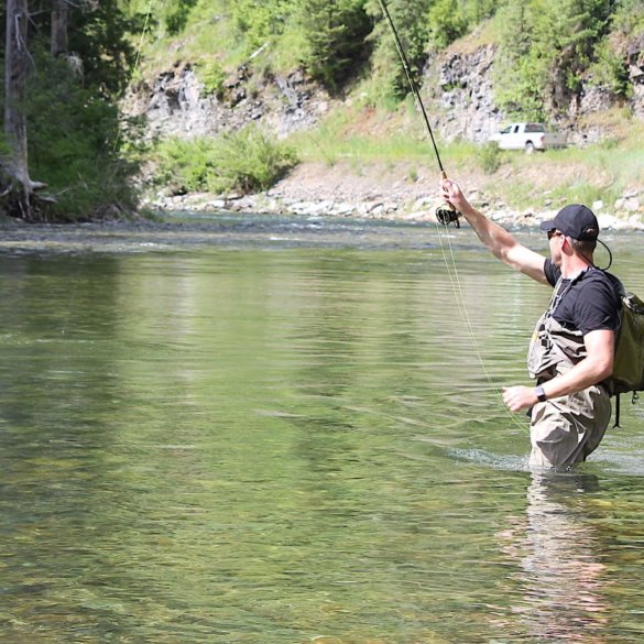 This Orvis Silver Sonic Convertible-Top Waders review photo shows a fly fisher wearing the Orvis waders in a river.