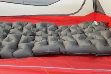 This image shows the Cabela's Ultralight Air Pad inside of a backpacking tent.