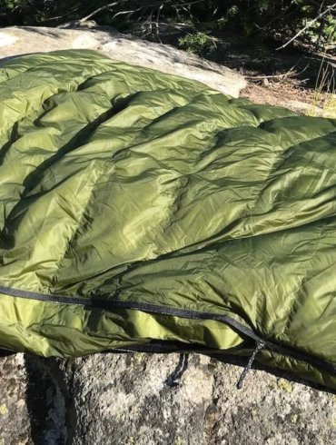 This image shows the Feathered Friends Flicker 20 Nano Down Quilt Sleeping Bag in the Eagle Cap Wilderness area.