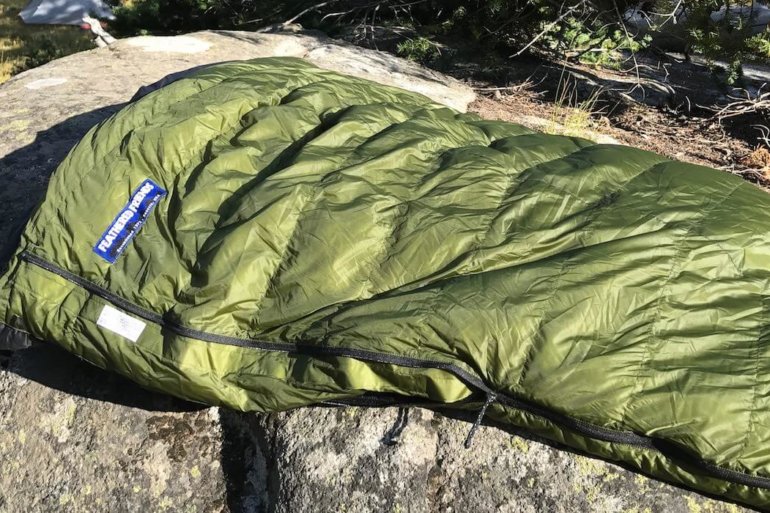 This image shows the Feathered Friends Flicker 20 Nano Down Quilt Sleeping Bag in the Eagle Cap Wilderness area.