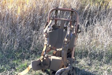 This image shows the SJK Rail Hauler 2.0 backpack in a field.