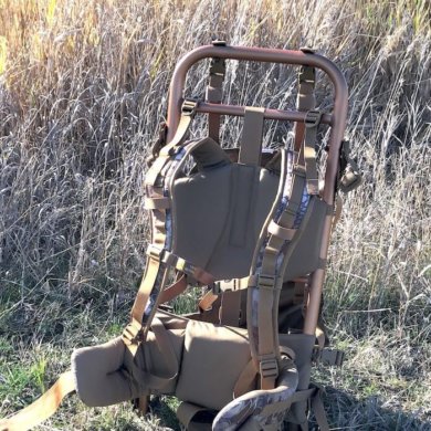 This image shows the SJK Rail Hauler 2.0 backpack in a field.