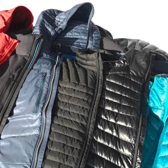 This photos shows multiple best down jackets together including the REI Co-op Magma 850 Down Jacket, Eddie Bauer MicroTherm StormDown Jacket, KUHL Spyfire Down Jacket and more.