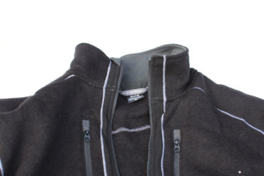 This photo shows the top half of the KÜHL INTERCEPTR jacket on white snow background.