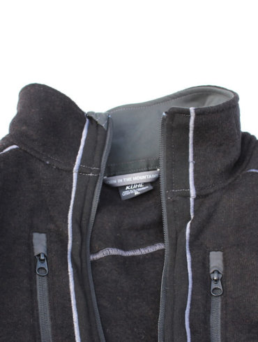 This photo shows the top half of the KÜHL INTERCEPTR jacket on white snow background.