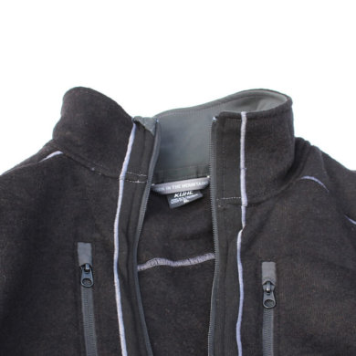 This photo shows the top half of the KÜHL INTERCEPTR jacket on white snow background.