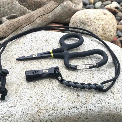 This photo shows the Loon Outdoors Rogue Quick Draw Forceps with the Nip n Sip 2.0 nippers on a river rock.