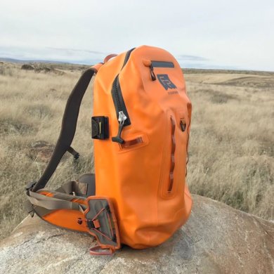 This photo shows the Fishpond Thunderhead Submersible Backpack outside on a rock.
