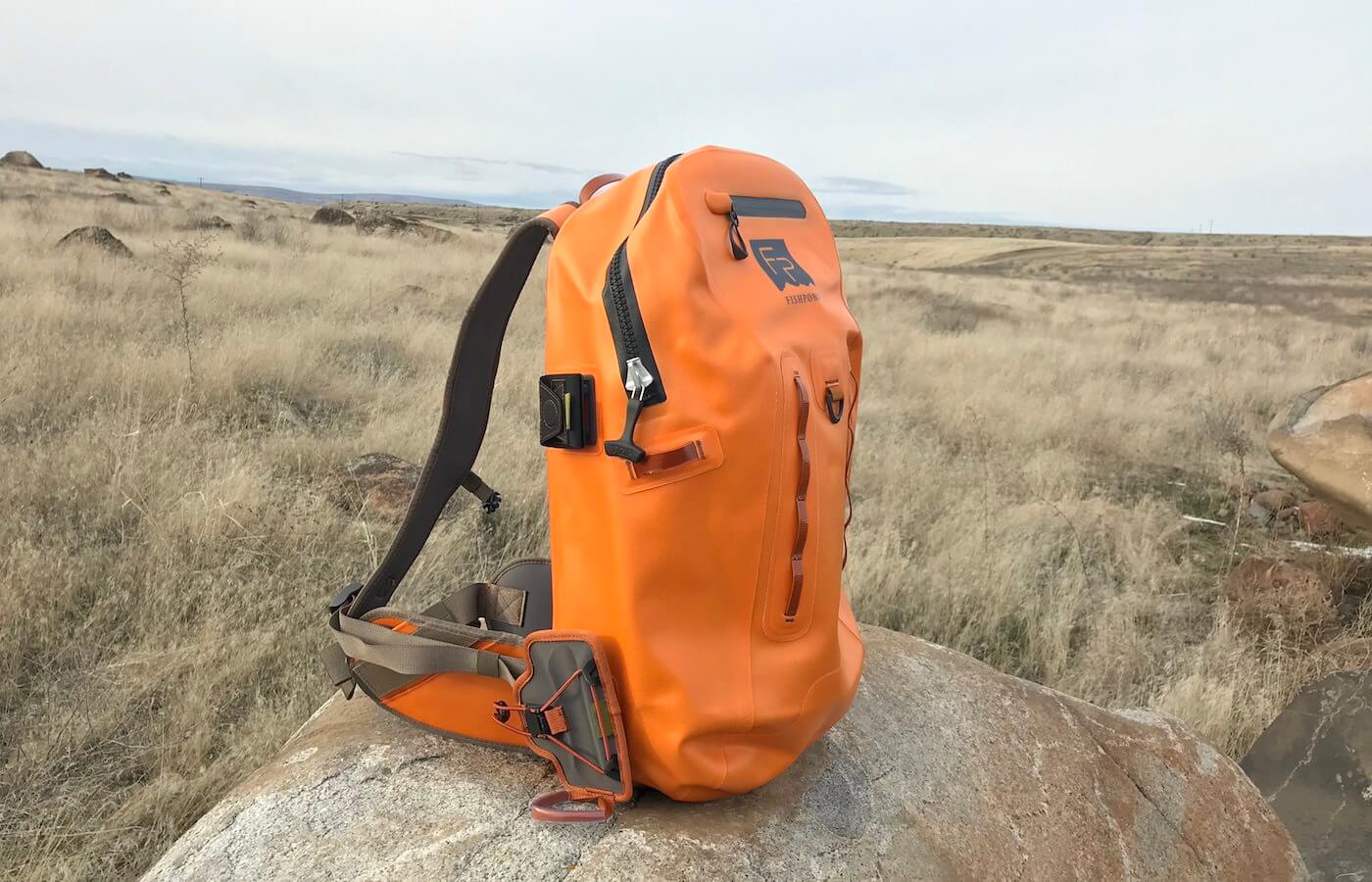 This photo shows the Fishpond Thunderhead Submersible Backpack outside on a rock.