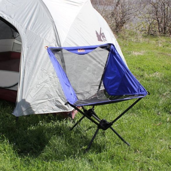 This camp chair photo shows the REI Co-op Flexlite Macro Chair in front of a tent.