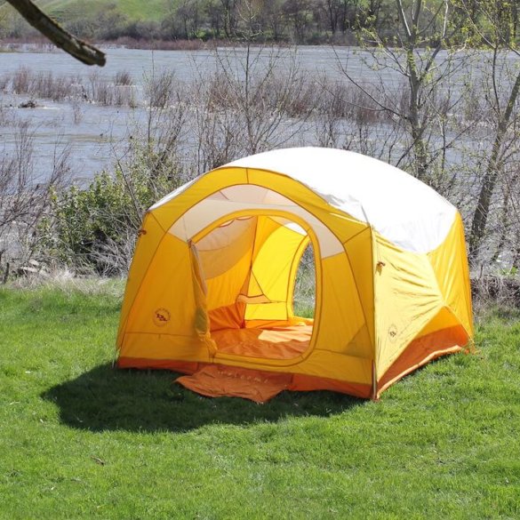This photo shows the Big Agnes Big House 4 Deluxe camping tent set up near a river.