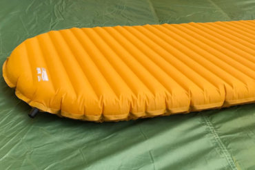 This photo shows the Therm-a-Rest NeoAir XLite air mattress backpacking sleeping pad on a tent floor.