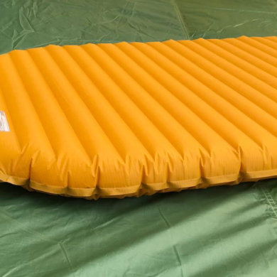 This photo shows the Therm-a-Rest NeoAir XLite air mattress backpacking sleeping pad on a tent floor.