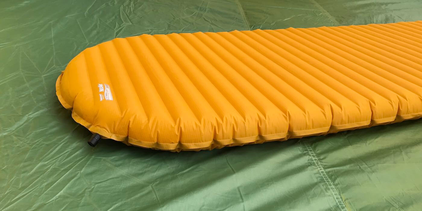 This photo shows the Therm-a-Rest NeoAir XLite air mattress backpacking sleeping pad on a tent floor.