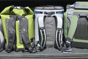 This photo shows several backpack coolers in a row, including the YETI Hopper BackFlip 24, OtterBox Trooper LT 30, and ICEMULE Pro.
