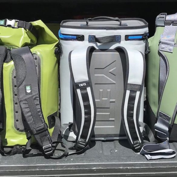 This photo shows several backpack coolers in a row, including the YETI Hopper BackFlip 24, OtterBox Trooper LT 30, and ICEMULE Pro.