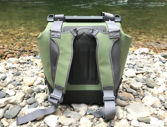 This photo shows the OtterBox Trooper LT 30 backpack cooler near a river.