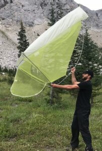 This photo shows the author holding the Big Agnes Fly Creek HV2 Platinum Tent up in the air.