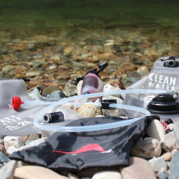 This photo shows the MSR Trail Base Water Filter Kit near a river.