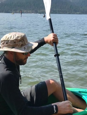 This photo shows the author wearing the Shelta Seahawk hat in a kayak on a lake.