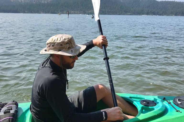 This photo shows the author wearing the Shelta Seahawk hat in a kayak on a lake.