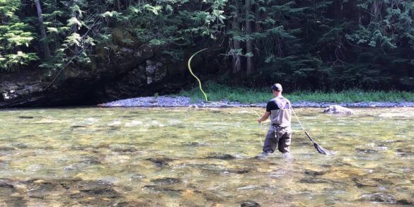 This photo shows a fly fisherman wading in a river while wearing the Redington Prowler Wading Boots.
