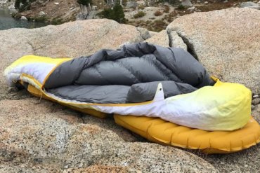 This photo shows the Therm-a-Rest Parsec 20 sleeping bag near a mountain lake.