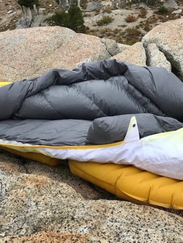 This photo shows the Therm-a-Rest Parsec 20 sleeping bag near a mountain lake.
