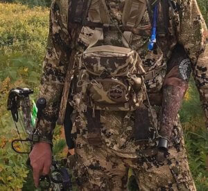 This photo shows the Alaska Guide Creations Classic MAX Pack Bino Harness worn on an archery hunter.