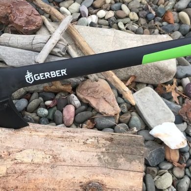 This photo shows the Gerber 23.5" Axe sticking into a piece of firewood.