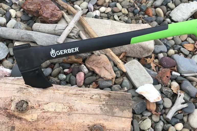 This photo shows the Gerber 23.5" Axe sticking into a piece of firewood.