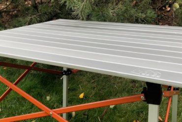 This photo shows the REI Co-op Camp Roll Table outside at a camping spot.