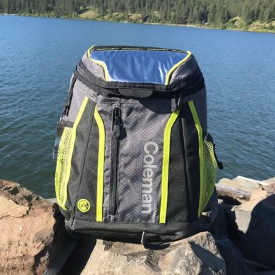 This image shows the Coleman Maverick Ultra Backpack Cooler near a lake.