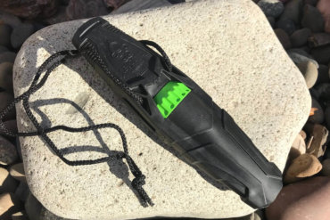 This photo shows the Primos Revolver Deer Call outside on a rock.