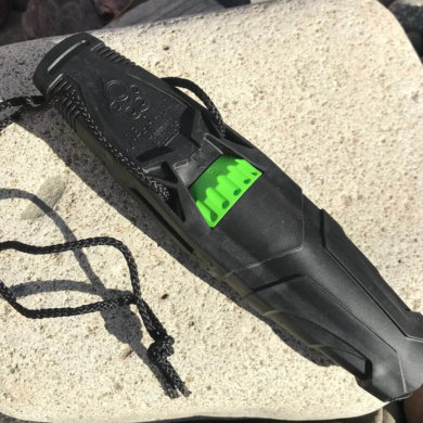 This photo shows the Primos Revolver Deer Call outside on a rock.