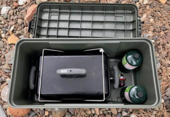 This photo shows the Plano Sportsman's Trunk medium with a Weber Go-Anywere grill inside.