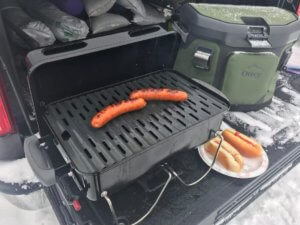 This photo shows the Weber Go-Anywhere Gas Grill on the tailgate of a pickup.