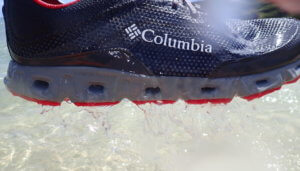 This photo shows water pouring out of the Columbia Drainmaker IV water shoes soles.
