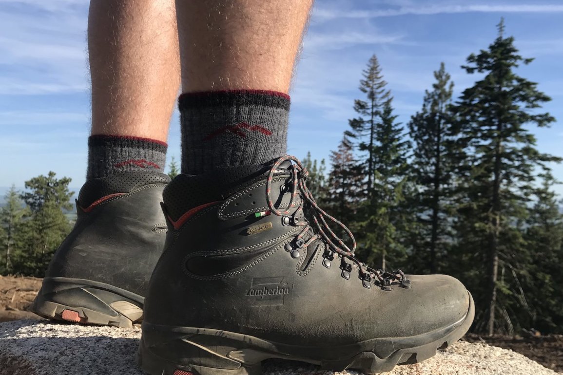 This Darn Tough sock review photo shows the Darn Tough Hiker Boot Sock Full Cushion Sock being worn by a hiker.
