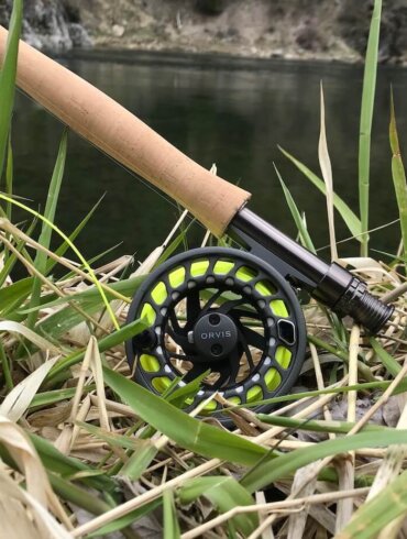 Clearwater Fly Rod Outfit in the 9-foot 5-weight version on a grassy bank near a trout stream.