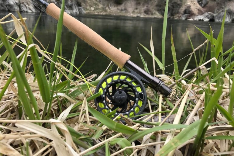 Clearwater Fly Rod Outfit in the 9-foot 5-weight version on a grassy bank near a trout stream.