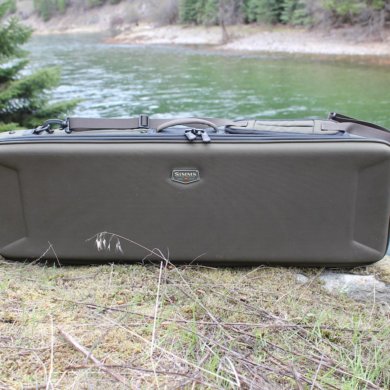 The review photo shows the Simms Bounty Hunter Vault Duffel outside near a river.