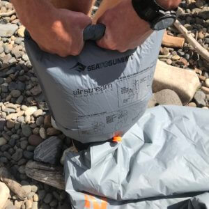 This photo shows the Airstream pump sack being used to fill the Sea to Summit Ether Light XT Insulated Air Sleeping Mat.