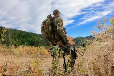 This photo shows a hunter wearing the Mystery Ranch Mule backpack outside.