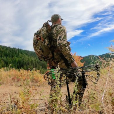 This photo shows a hunter wearing the Mystery Ranch Mule backpack outside.