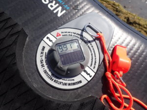 This review photo shows the TRīB airCap Pressure Gauge on an inflatable paddle board.