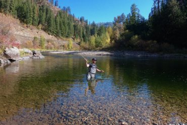 This photo shows a fly fisherman wading in a river while wearing the Orvis PRO Wader.