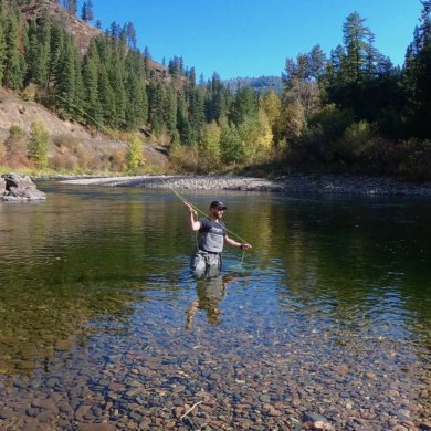 This photo shows a fly fisherman wading in a river while wearing the Orvis PRO Wader.