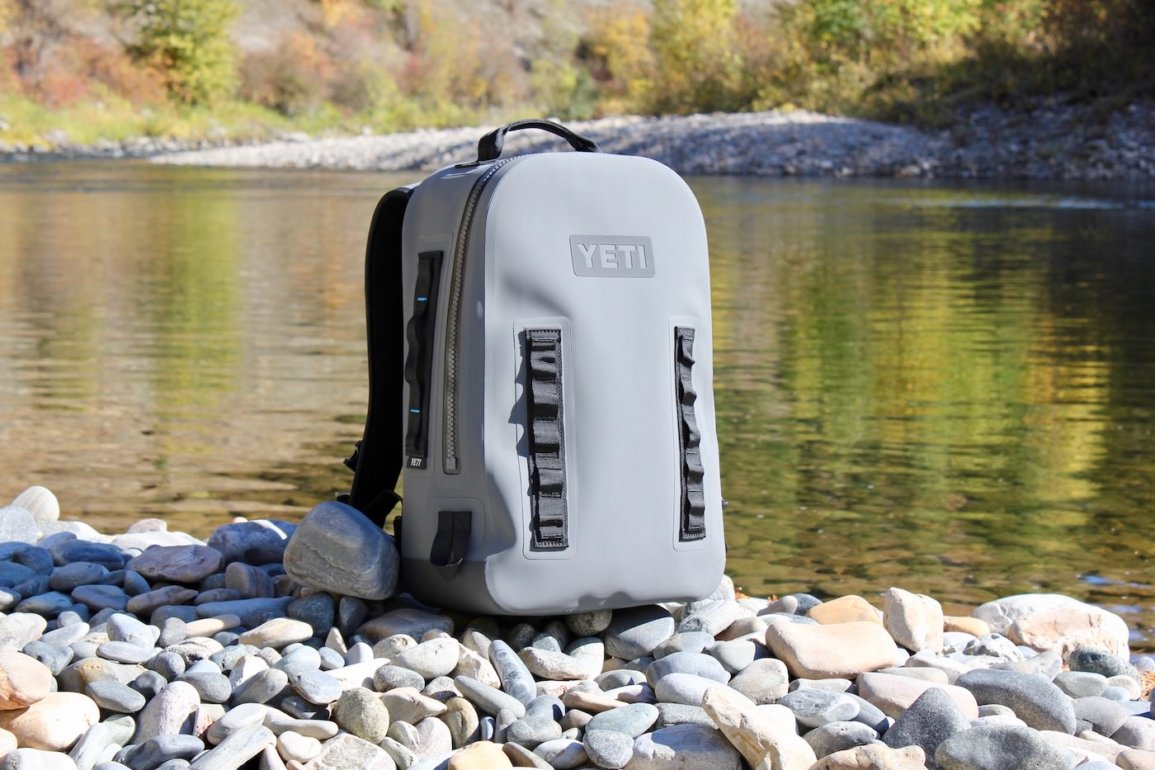 This photo shows the YETI Panga Backpack 28 on the side of a river.